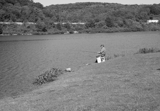 Man on Box Fishing in Lake